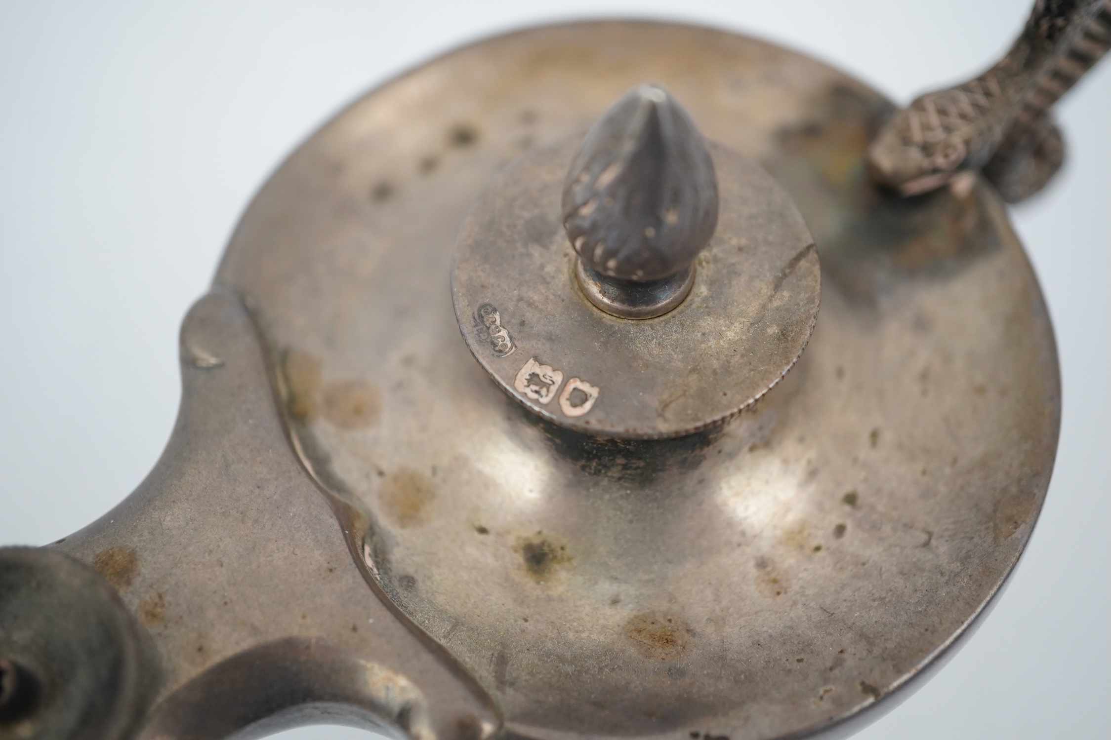 A late Victorian silver club lighter modelled as an oil lamp with serpent handle, Goldsmiths & Silversmiths Co Ltd, London, 1900, length 12cm. Condition - fair to good